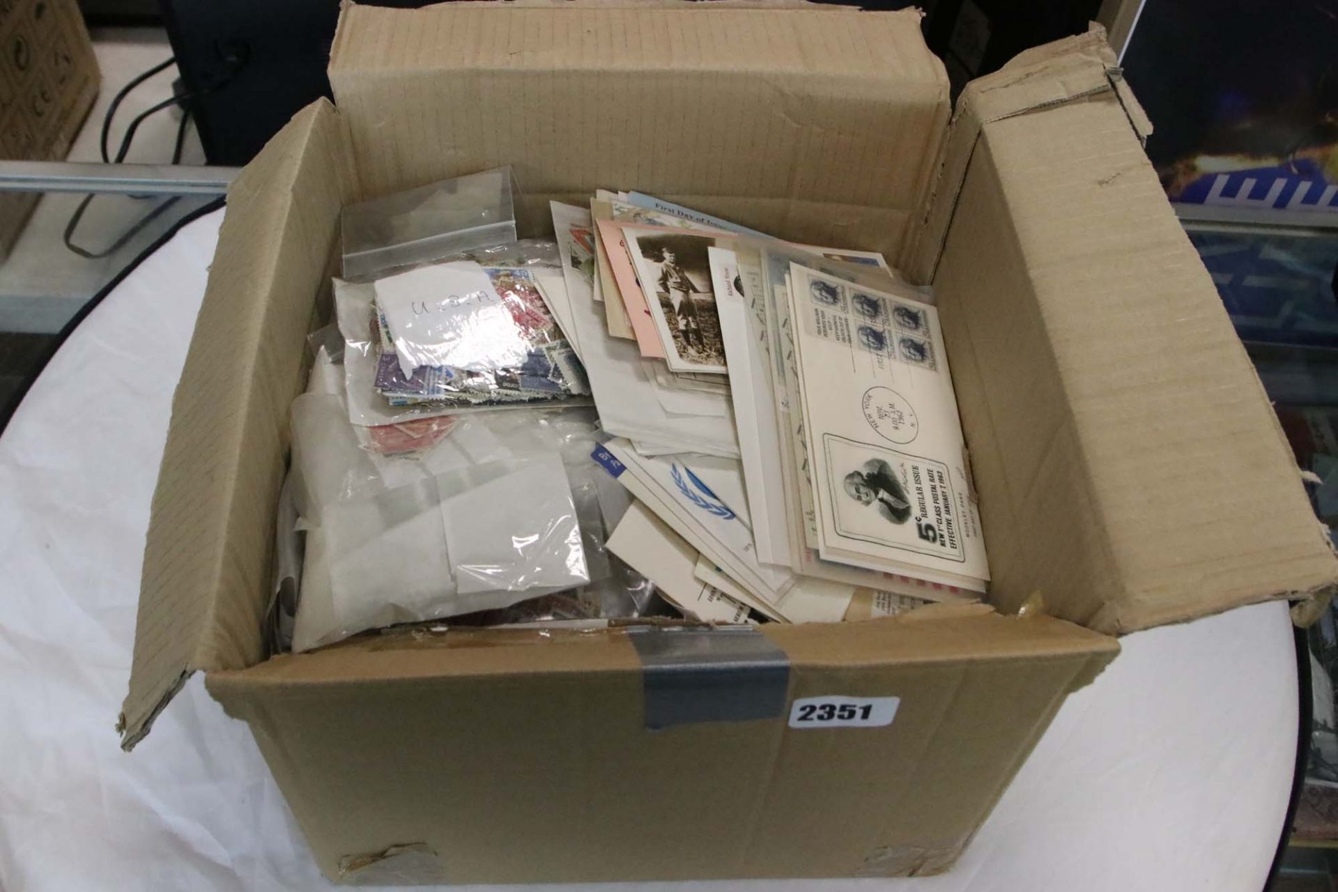 Box of first day covers and loose stamps