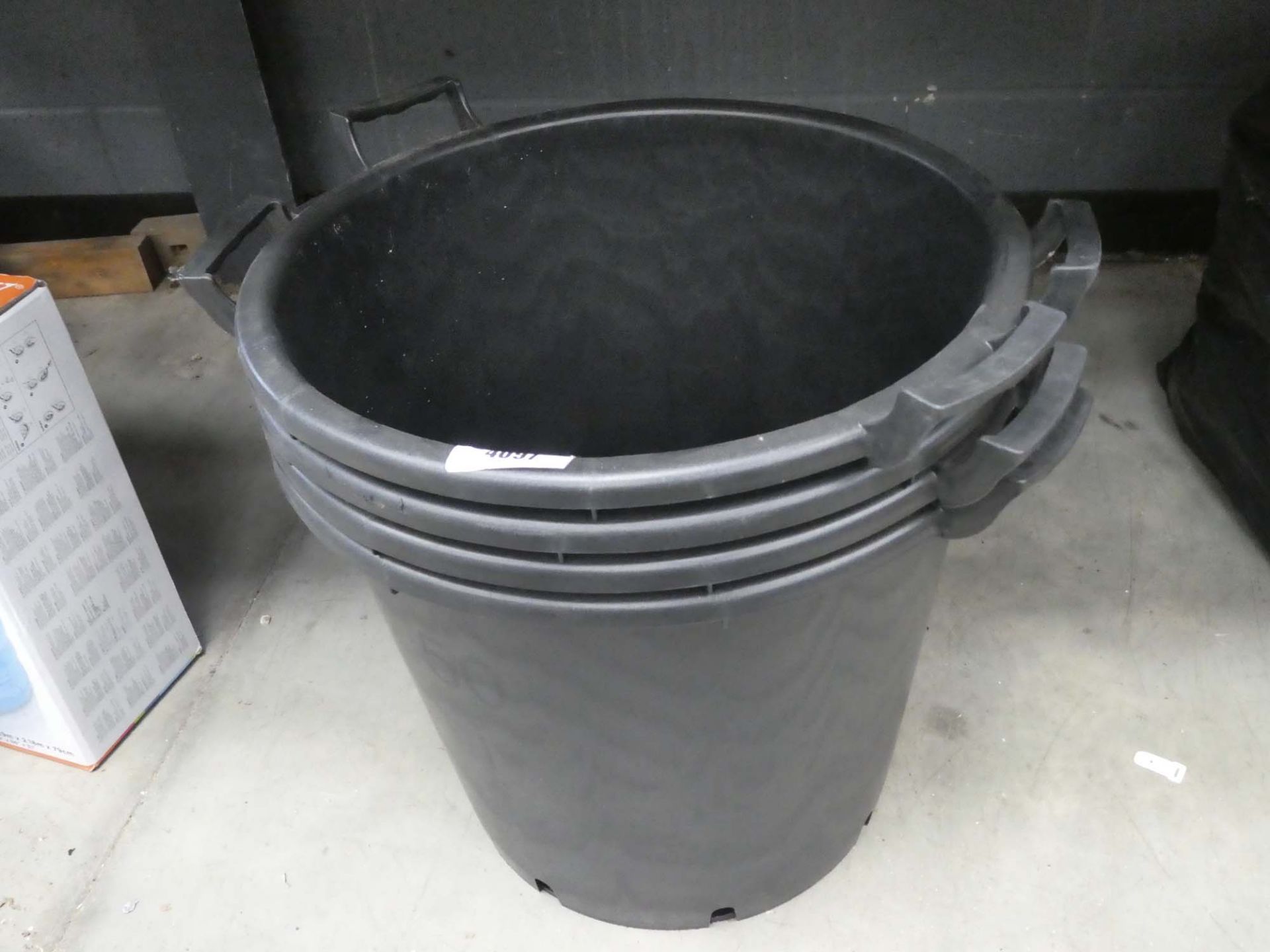 4 large black plastic buckets