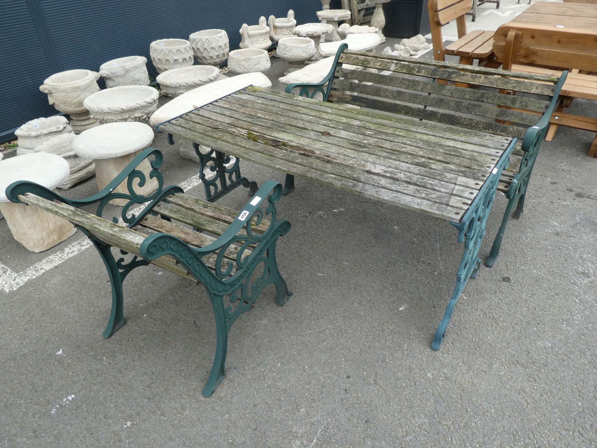 Wooden metal framed garden bench with metal wooden framed table and a chair