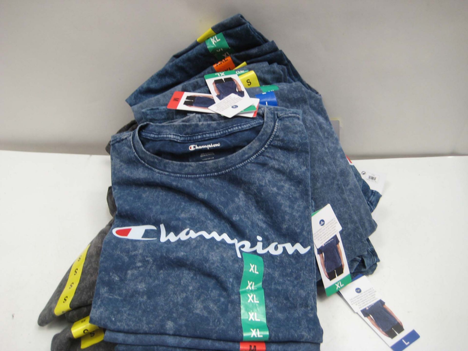 Bag containing ladies charcoal grey and blue t-shirts by Champion sizes ranging from XXL to M (