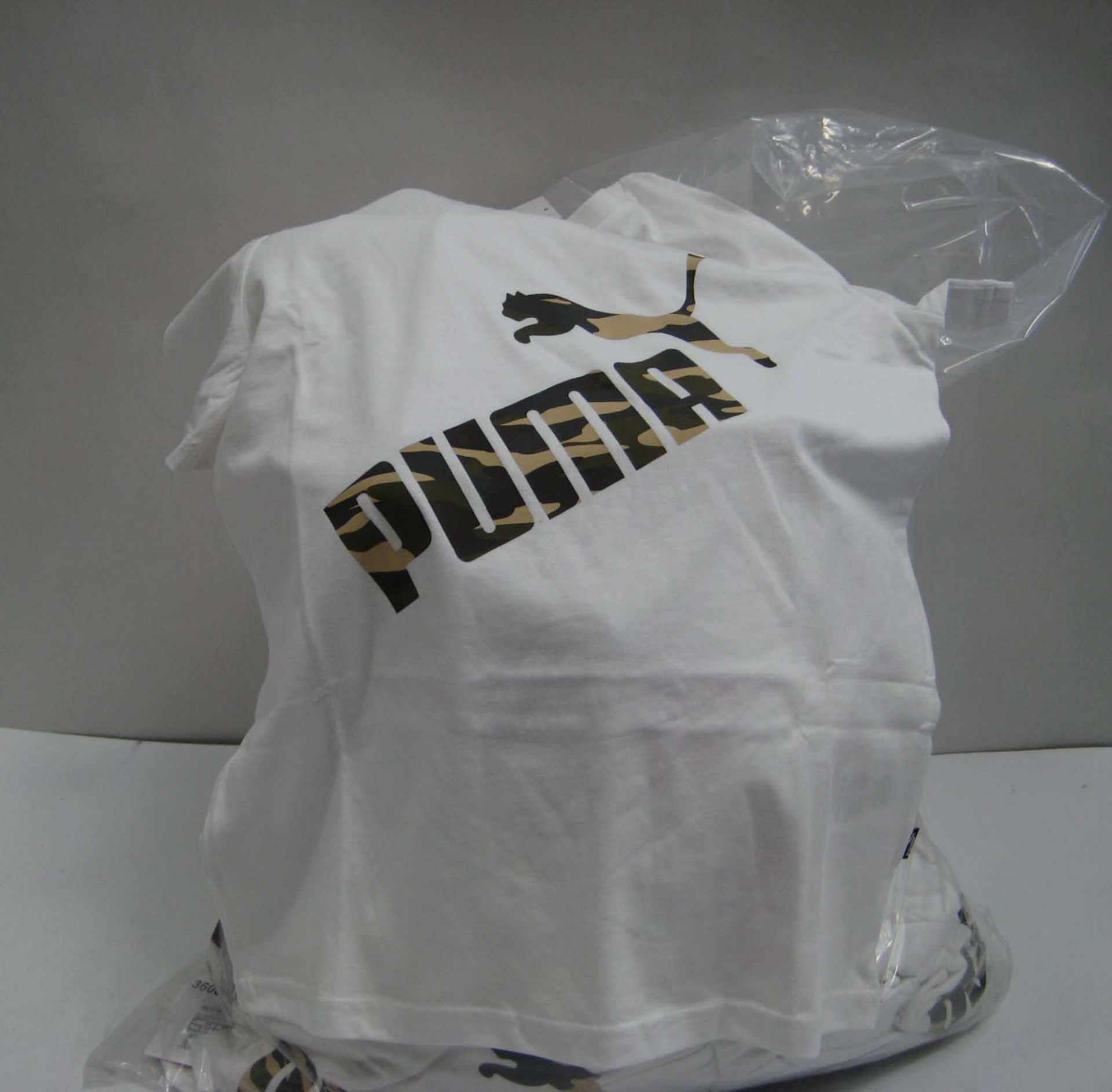 A bag containing approx 60 pairs of children's white Puma t shirts with camouflage Puma logo on