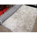 Large beige shag pile rug