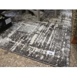 Rectangular mottled rug with grey and beige fleck pattern