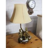 Table lamp with shade with two brass finish soldier ornaments