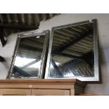 2 large silver coloured framed and bevelled wall mirrors