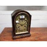 Chiming mantle clock in distressed wooden case