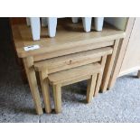 (11) Nest of three oak finish coffee tables