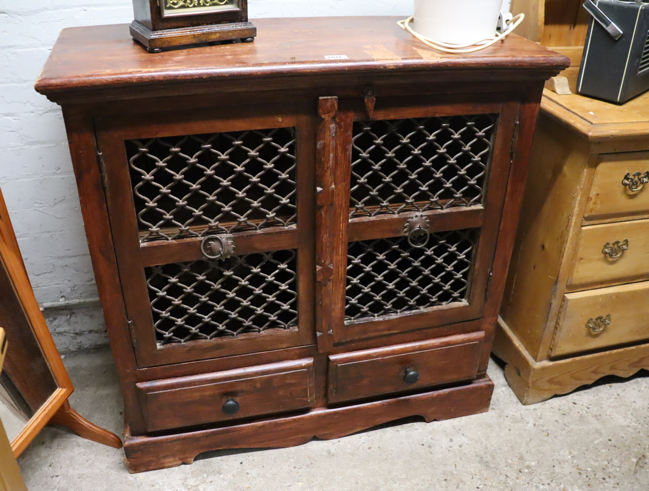 Oriental style cabinet with fret work doors and drawers under