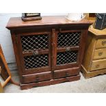 Oriental style cabinet with fret work doors and drawers under