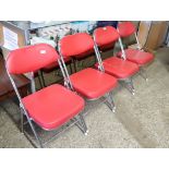 3 red leatherette upholstered folding chairs on chrome frames