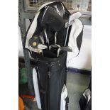 Black and grey Dunlop golf bag containing mixed branded golf clubs
