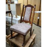 Carved walnut hand upholstered rocking chair