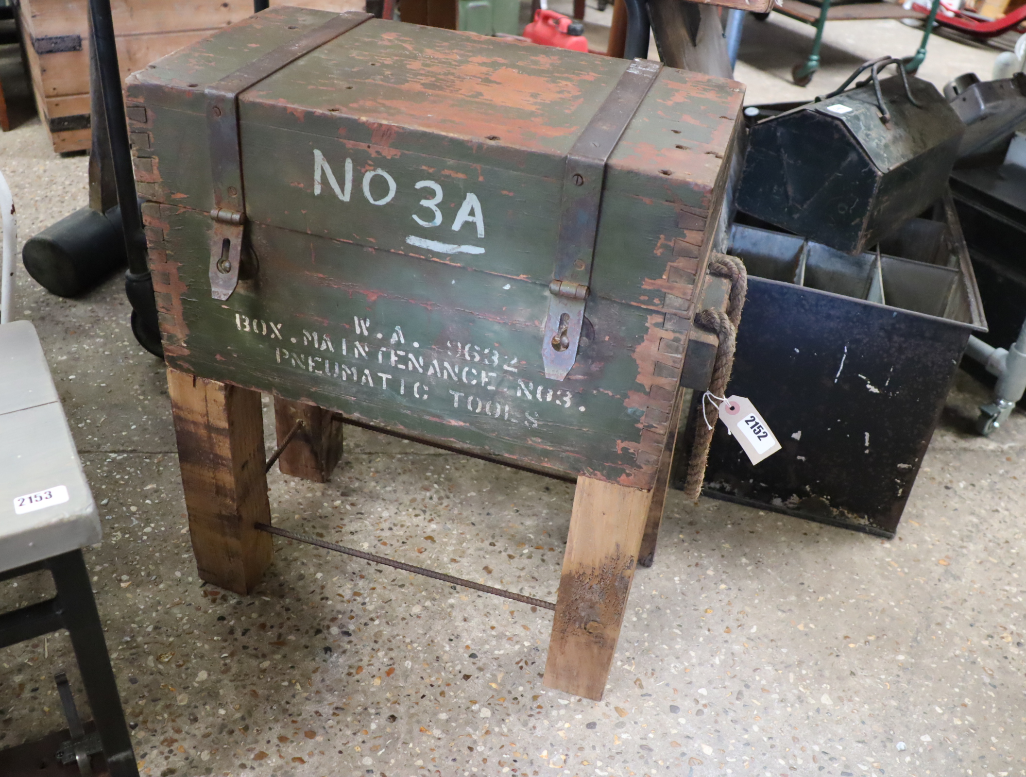 Vintage ammo crate raised on added wooden and metal plinth