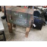 Vintage ammo crate raised on added wooden and metal plinth