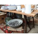 Wooden work table on industrial lead painted metal support