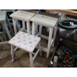 Pair of white painted laboratory stools and smaller foot stool