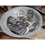 Galvanized planter with contents of various chrome letters