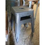 Pair of stackable industrial metal stools in grey