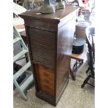 Dark oak slim tambour fronted pedestal having 8 internal drawers and bearing a plaque marked 'The