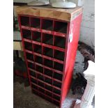 Red metal industrial pigeon hole rack with applied wooden surface