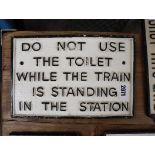 Reproduction 'Do not use the toilet while the train in standing in the station' plaque