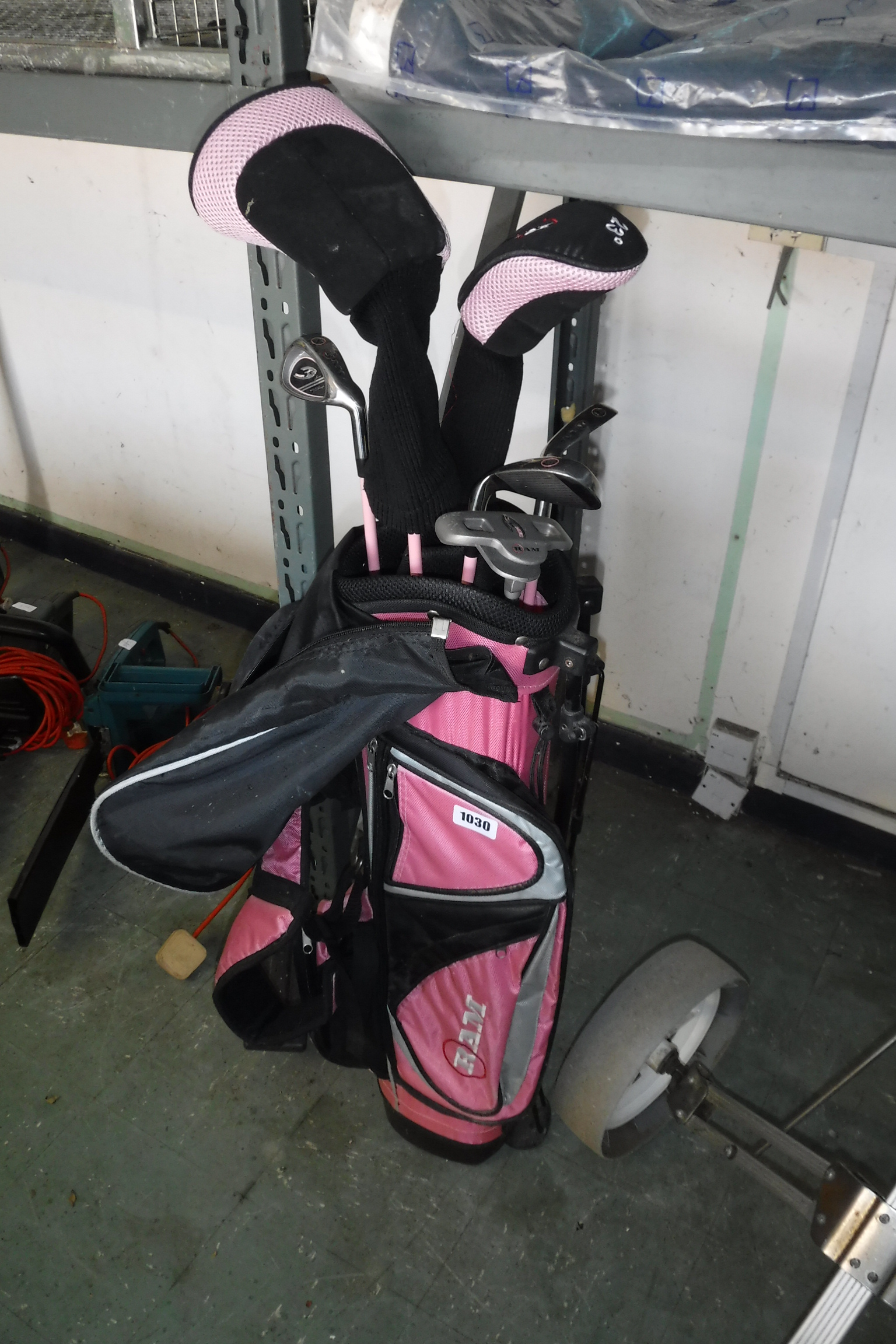 Ram golf bag in pink and black containing Ram girls golf clubs