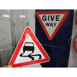 2 road signs; 'Slippery when wet' and 'Give way'