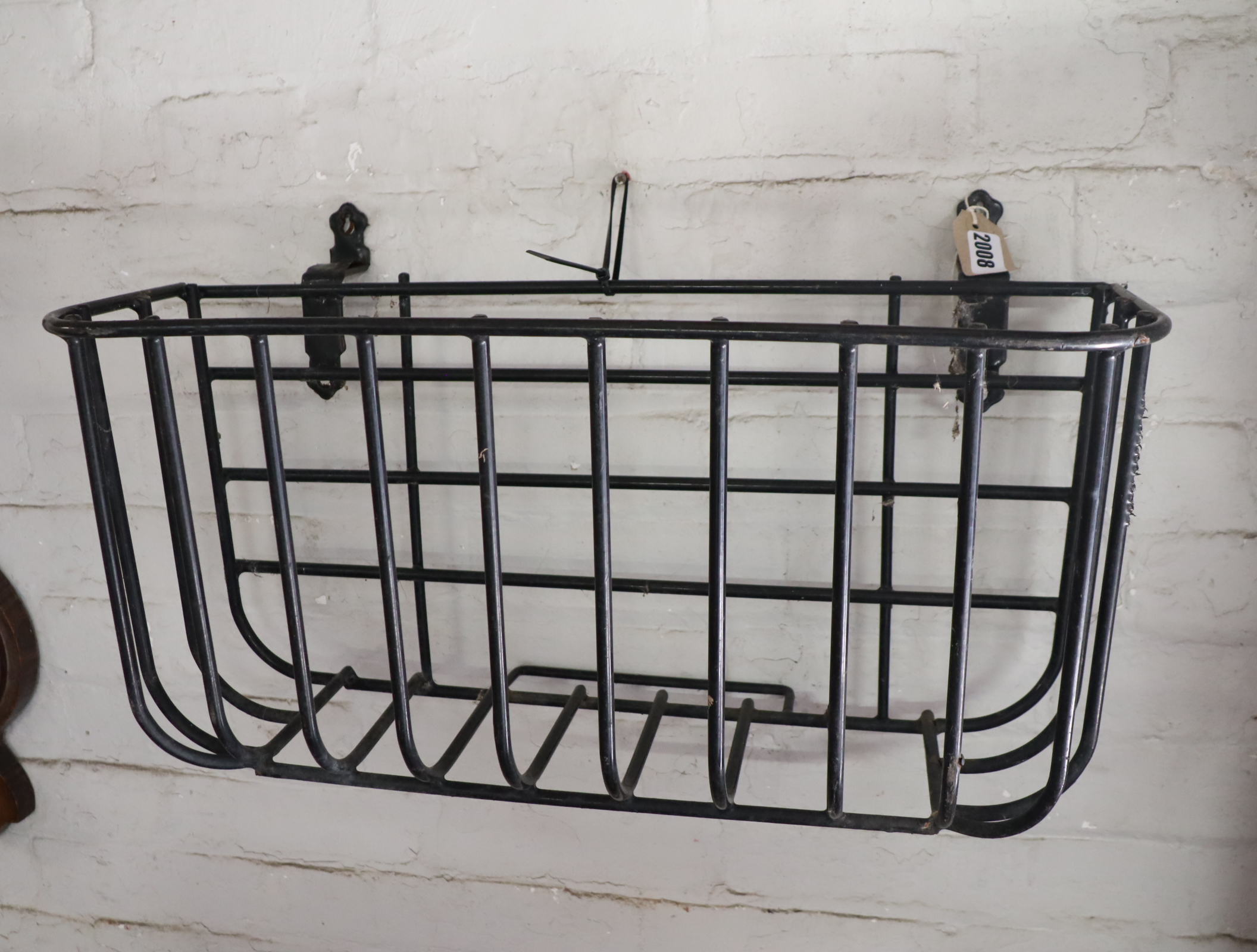 Black wrought metal wall hanging hay feeder