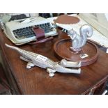 Small wooden tray adorned with squirrel together with crocodile nutcracker