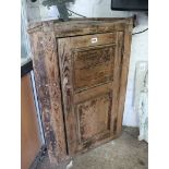 Stripped pine single door hanging corner cupboard