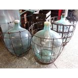 3 glass carboys in metal baskets
