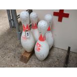 4 bowling pins, 1 adapted as a doorstop