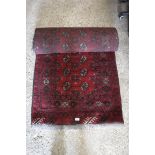 Black, red and beige figured and bordered hall runner