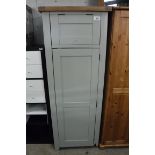 Green single door pantry cupboard with oak top