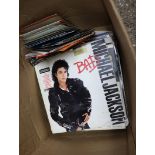 Crate containing vinyl albums and singles incl. Michael Jackson's Bad, Motor Head, etc.