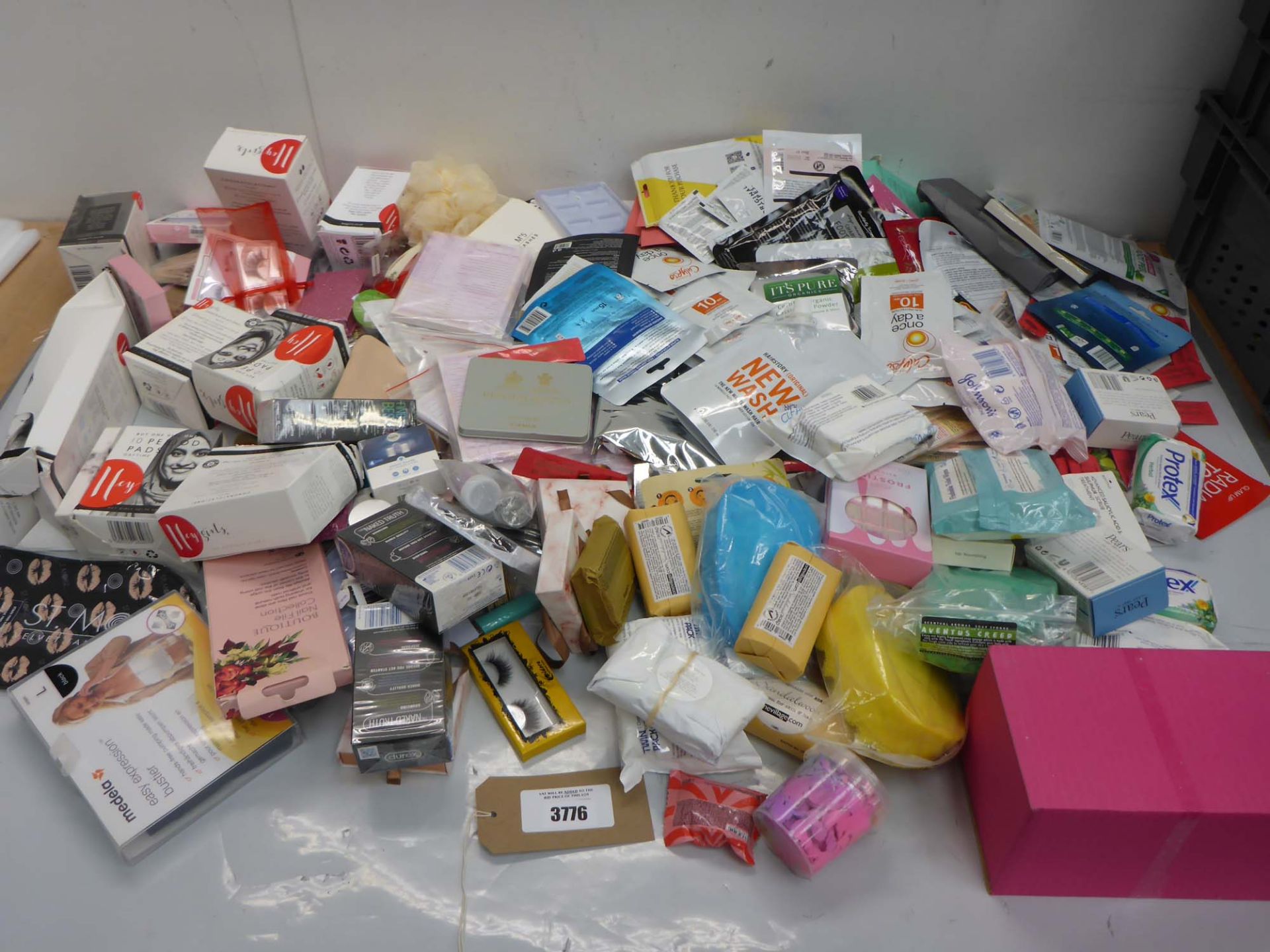 Bag containing soaps, bath bombs, face & feet masks, beauty product sample sachets, sanitary ware,