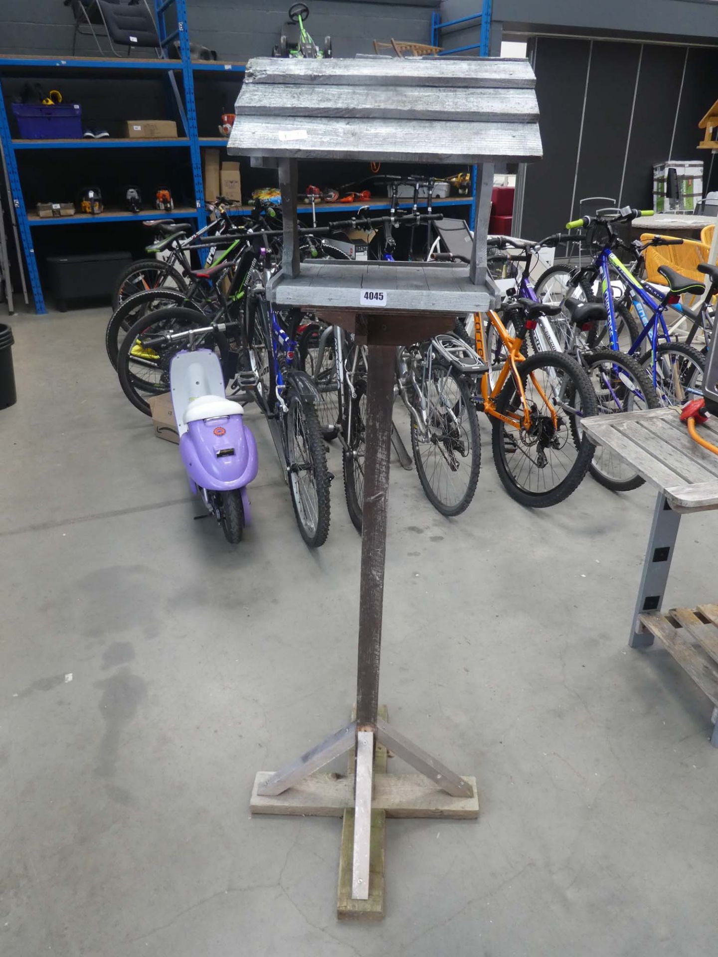 Wooden bird table on stand