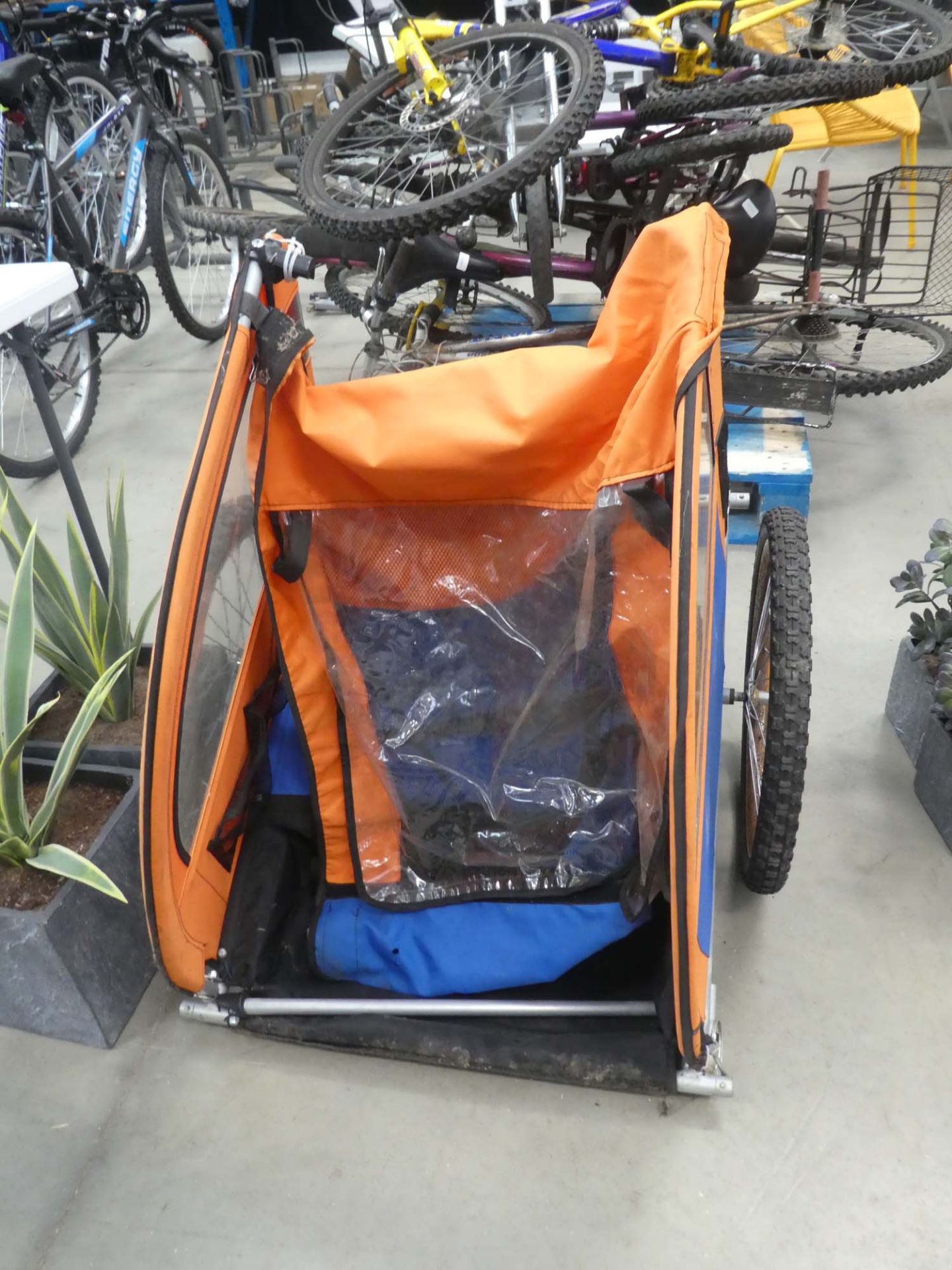 Bike trailer with orange and blue canopy