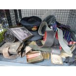 Cage containing military caps, photograph of a sergeant, webbing and used cartridges