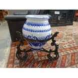 Blue and white plant pot on wrought iron tripod stand