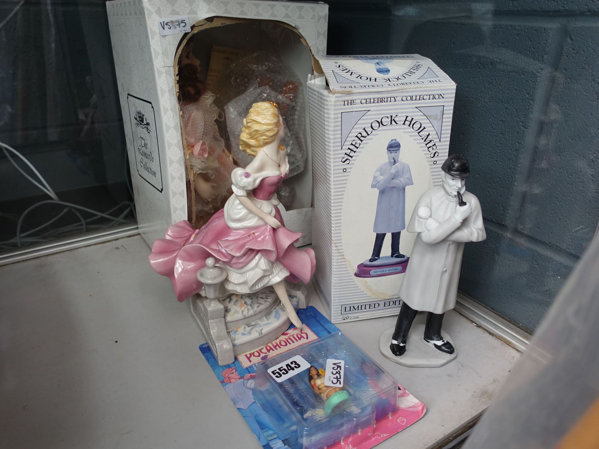 Leonardo figure of a lady, a Doulton figure, a Sherlock Holmes figure and a Disney Pocahontas toy