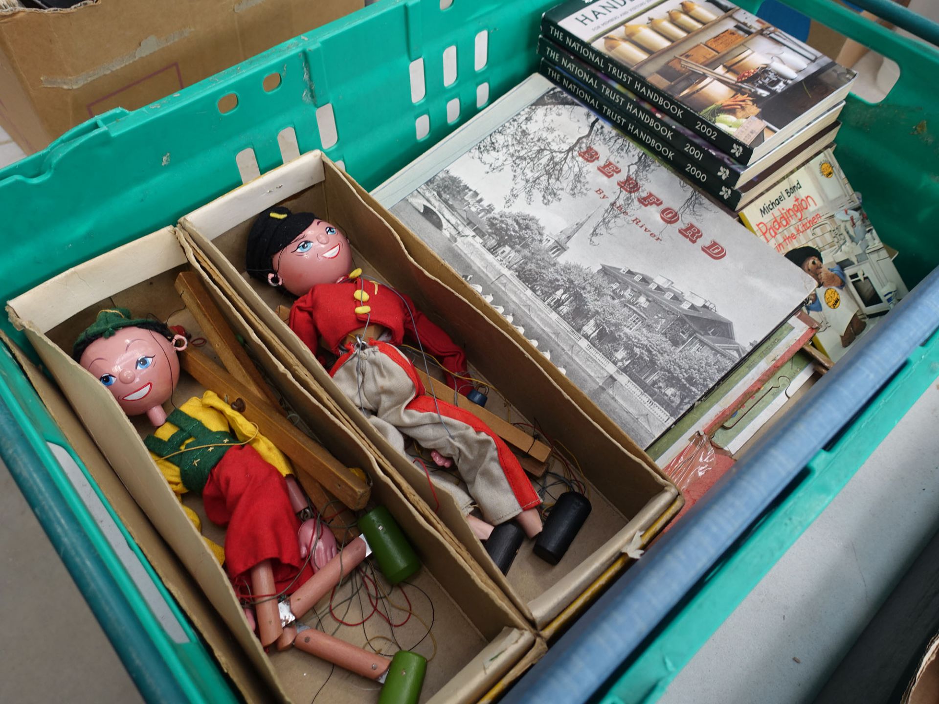 Box containing 2 Pelham puppets, National Trust and other handbooks plus a Bedford book