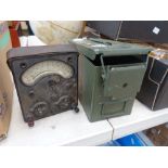 Metal military ammunition box with spent cartridges plus volt meter