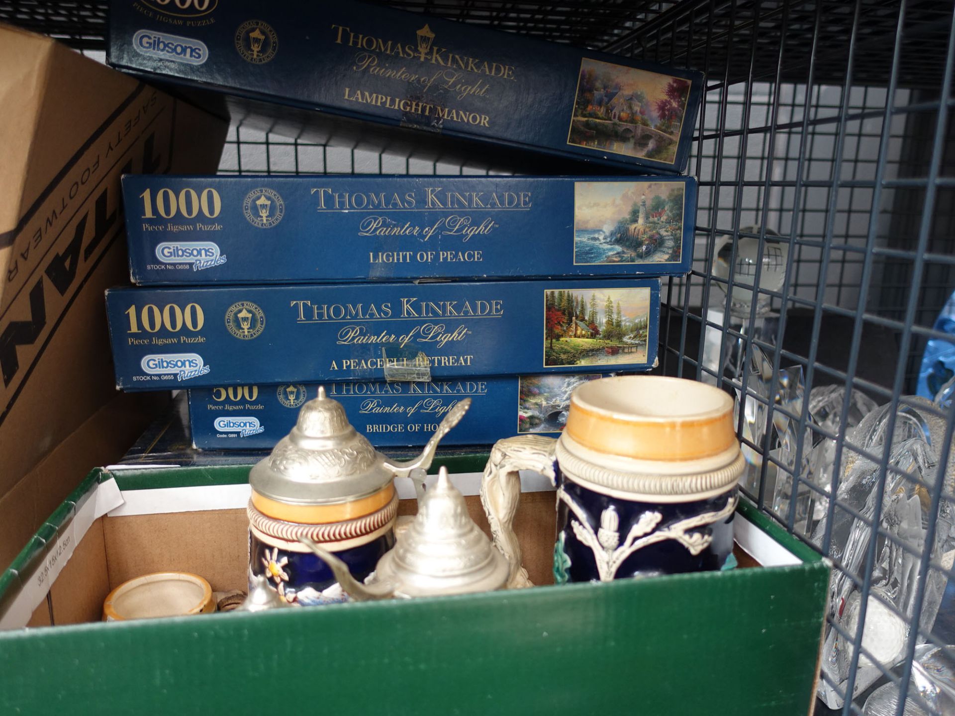 Cage containing jigsaw puzzles, marbles and beer steins