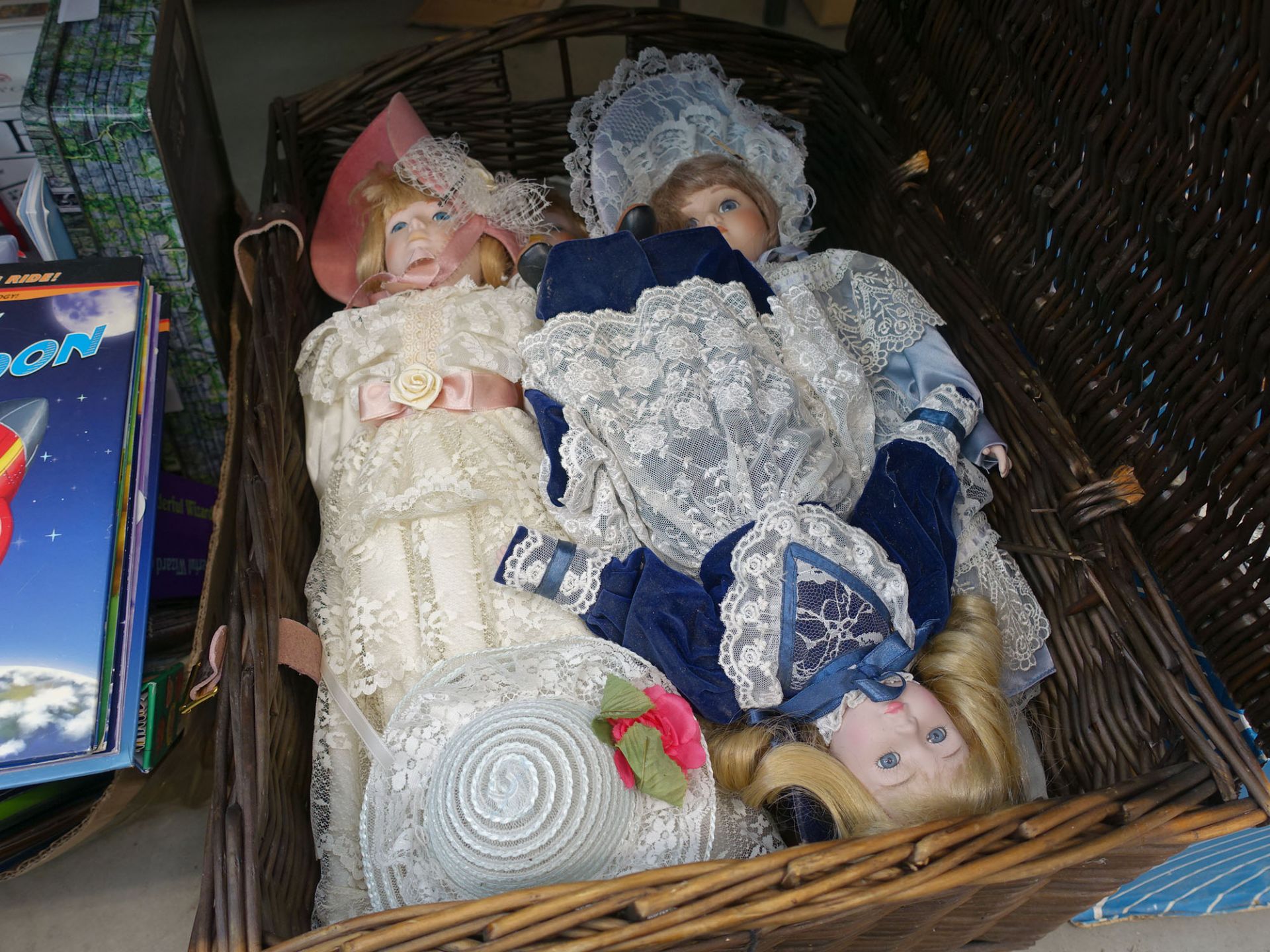 Wicker basket with quantity of porcelain dolls