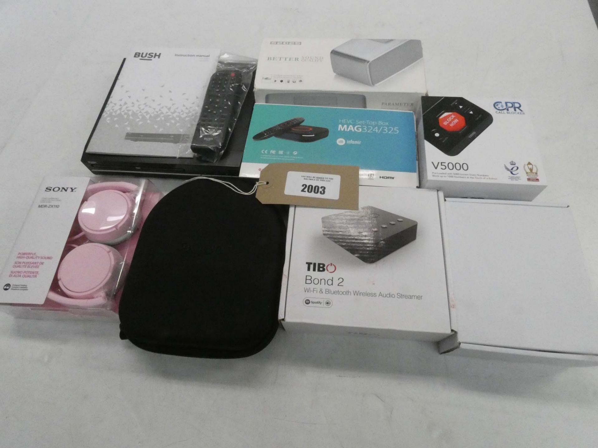 Bag containing Bush DVD player, Sony headphones, headset, bluetooth speaker, Tibo audio streamer,