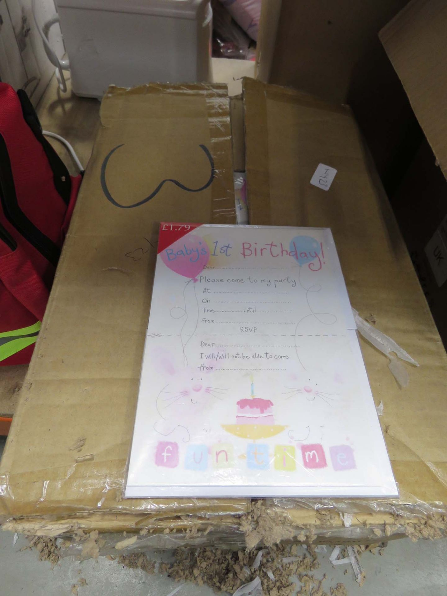 Box containing birthday invitations with envelopes