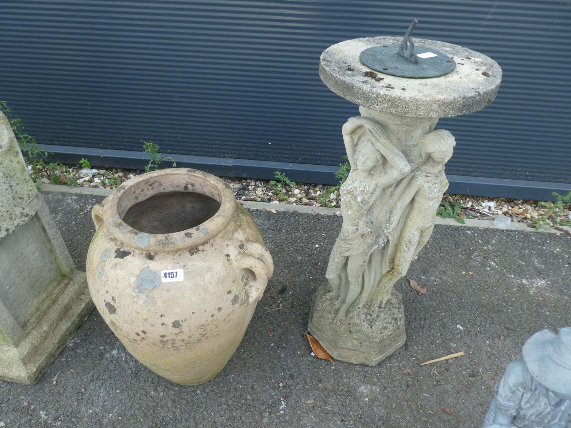 Concrete statue of lady (broken base), urn-style planter, and sundial