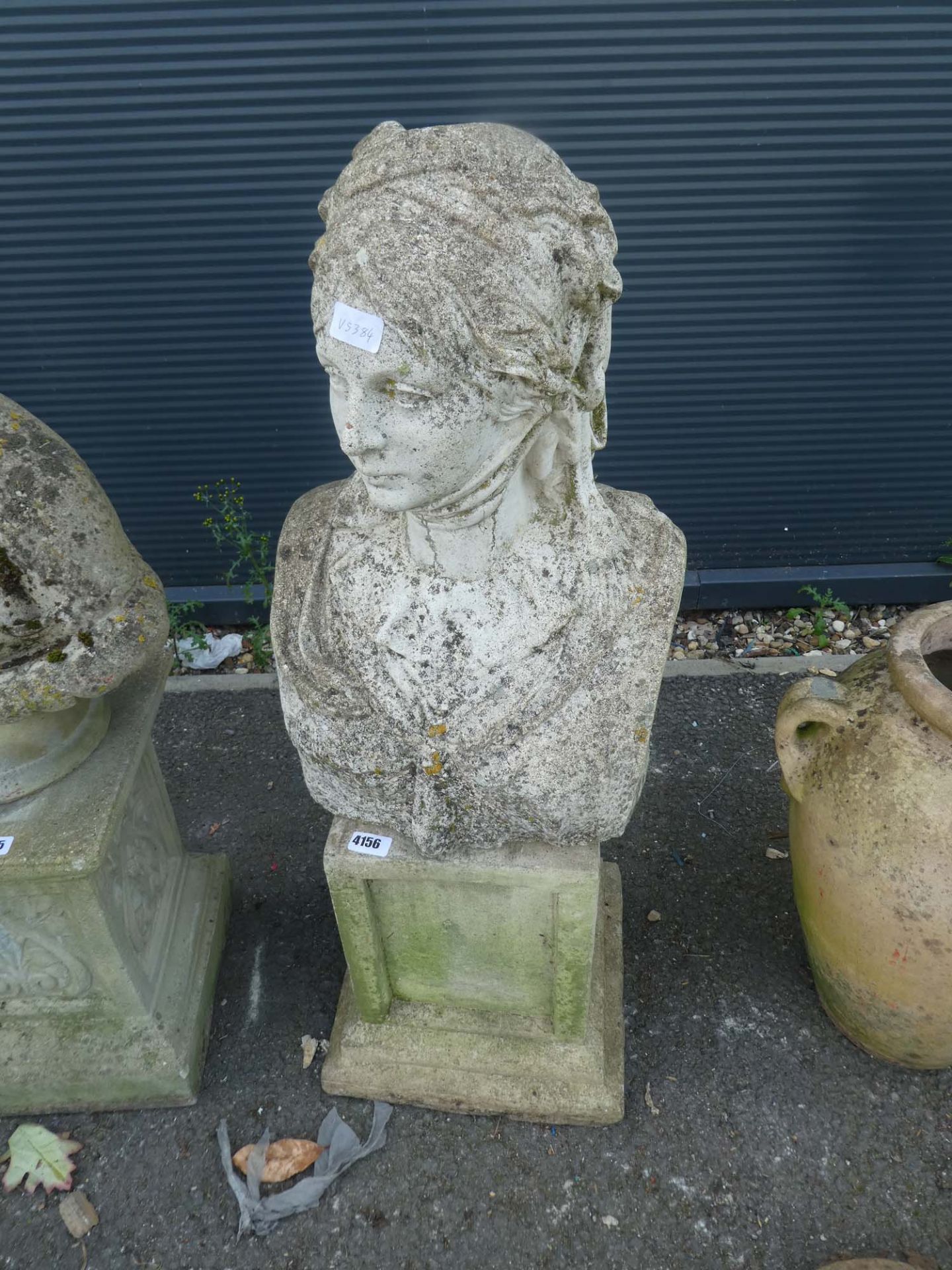 Concrete bust on plinth