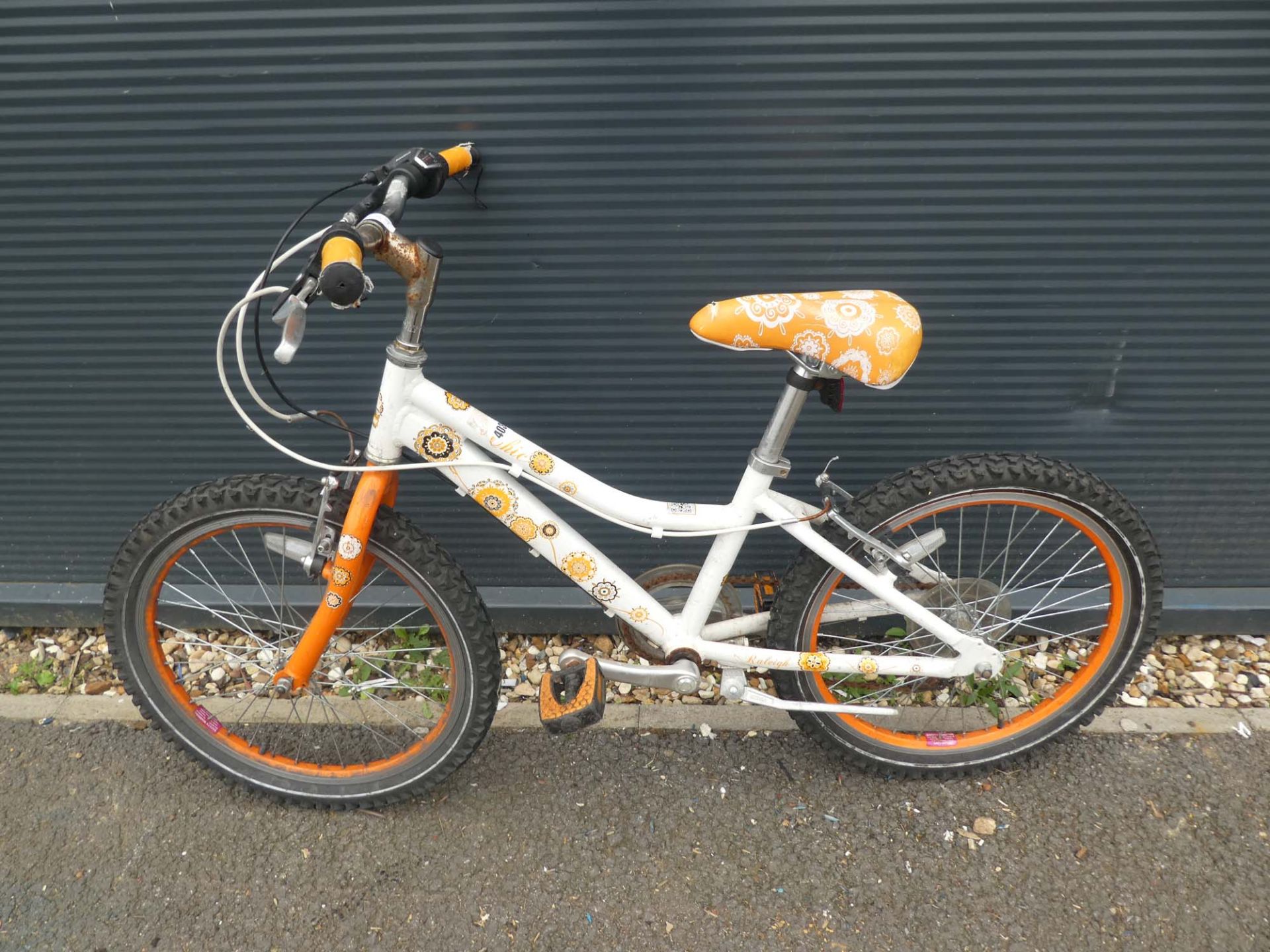 Orange and white childs bike